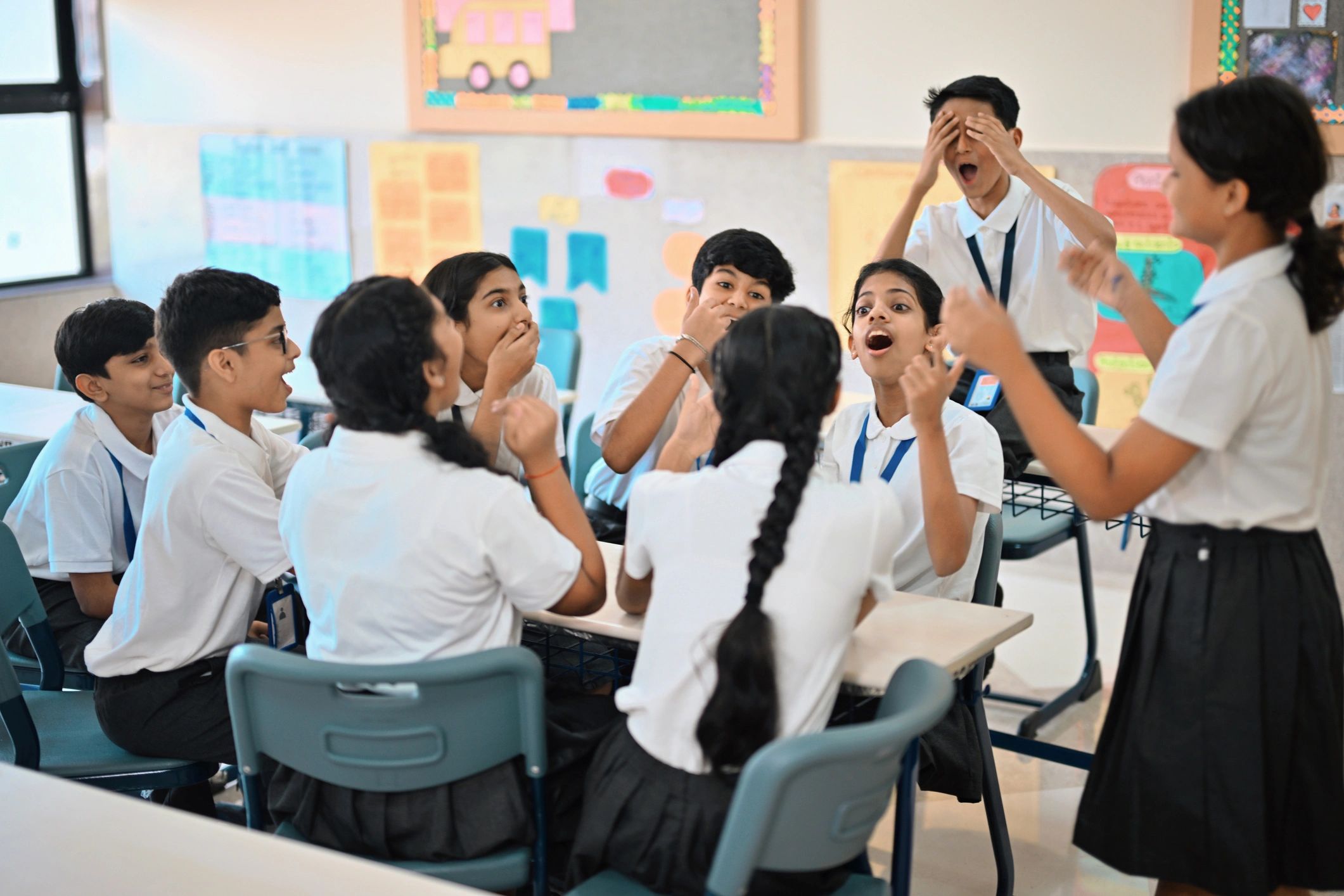 Schoolchildren gathered around a classroom table